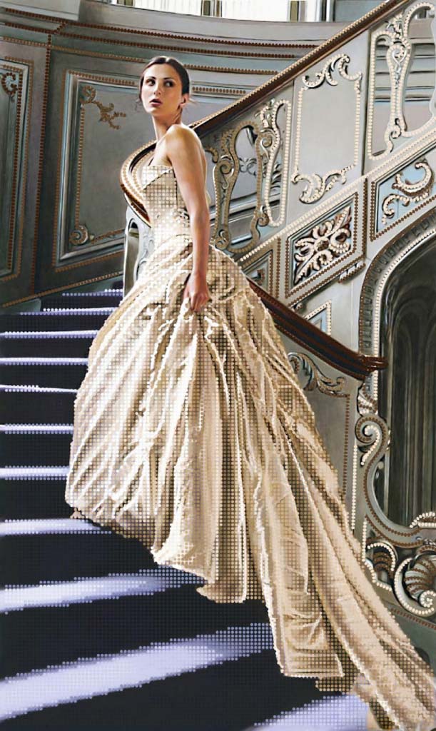 Woman in a flowing dress standing on an ornate staircase