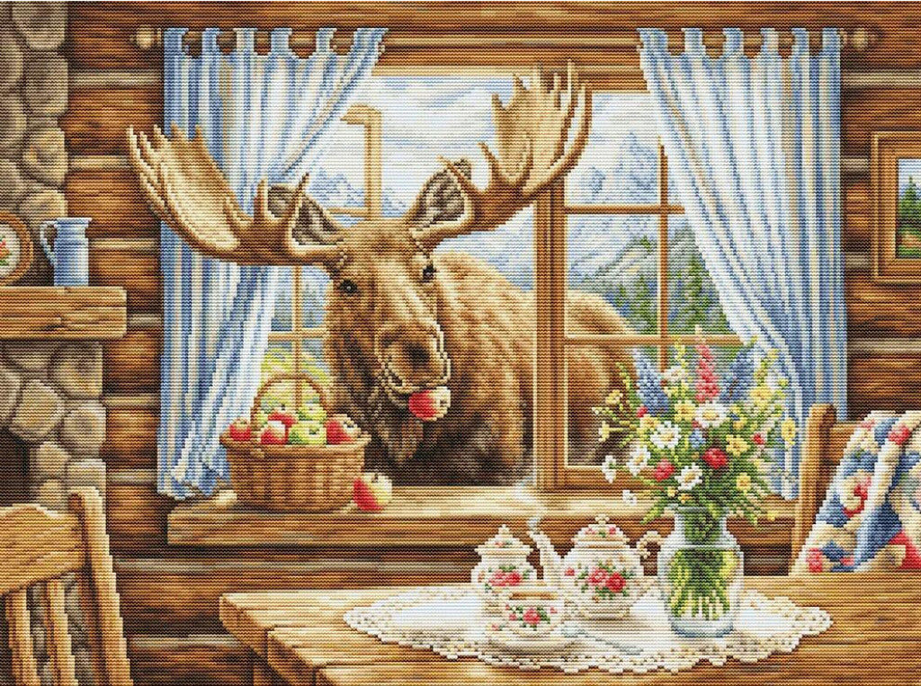 A cozy rustic cabin interior with a large moose peeking through a window with blue curtains, holding an apple in its mouth. A basket of fruit sits on the windowsill, and a table in the foreground holds floral arrangements and teapots.