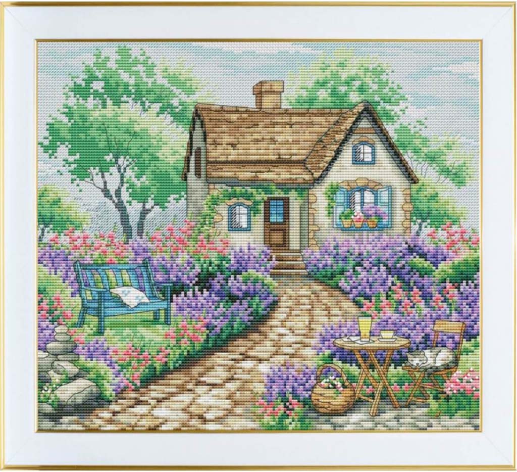 Cross-stitched depiction of a quaint house with a garden and bench
