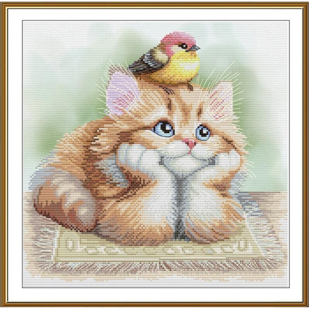 A framed needlepoint or cross-stitch style artwork showing a fluffy orange tabby kitten with blue eyes resting on a patterned rug, with a small pink-and-yellow bird perched on its head, set against a soft pale green background.