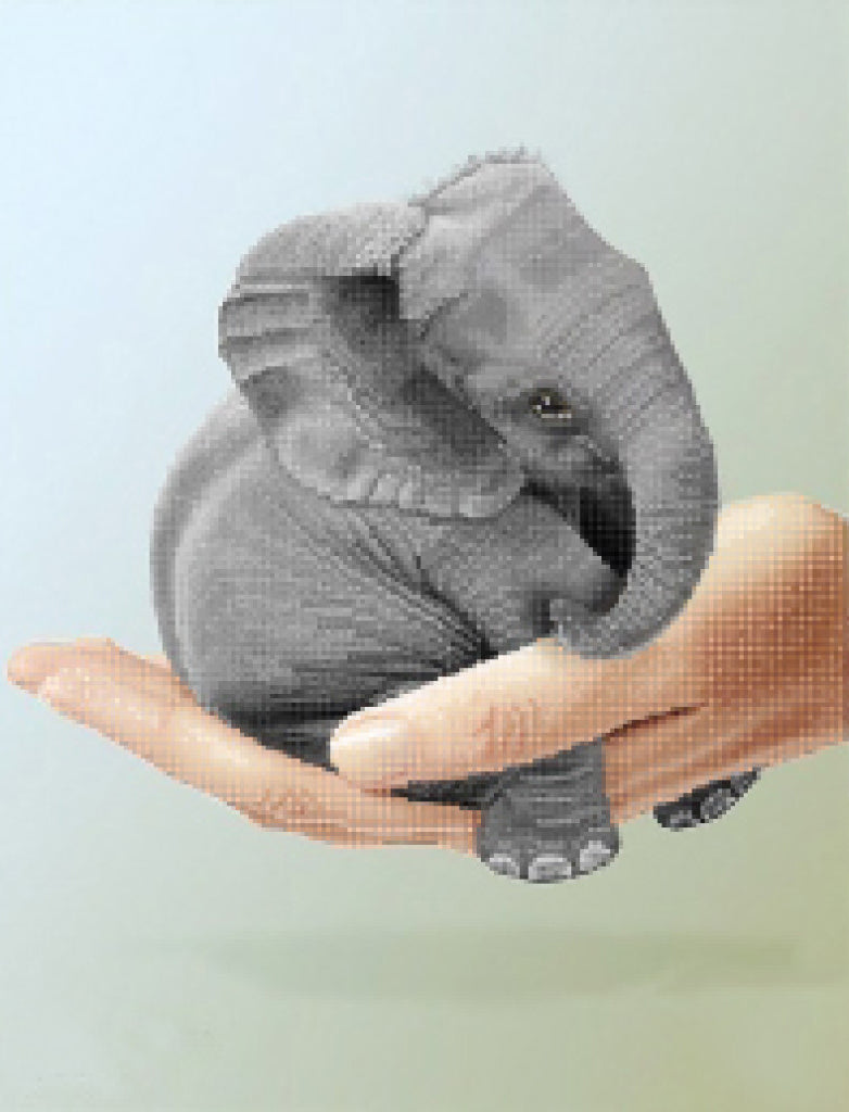 Small elephant toy held in a hand against a light background