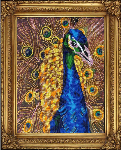 A beaded embroidery kit depicting a peacock with a printed pattern, beads, and a gold-colored frame.