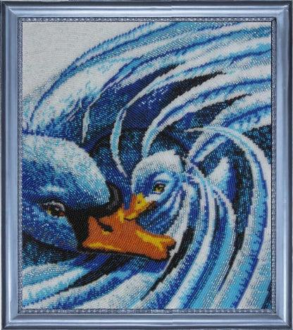 A beaded embroidery kit depicting two swans with blue and white colors on a printed fabric pattern.