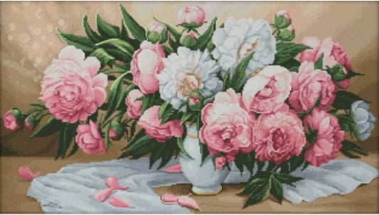 Bouquet of pink and white flowers in a vase on a textured surface