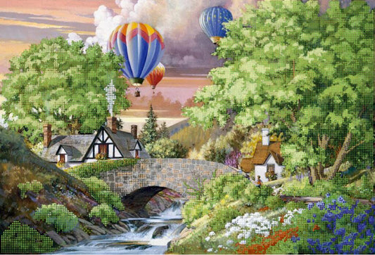 Landscape with houses, a bridge, and hot air balloons in the sky.