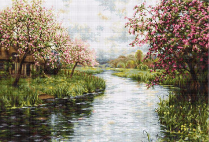 A tapestry embroidery kit depicting a spring landscape with trees in bloom, a river, and a house.