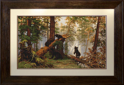 A framed tapestry embroidery kit depicting a morning in the pine forest scene with two bears.