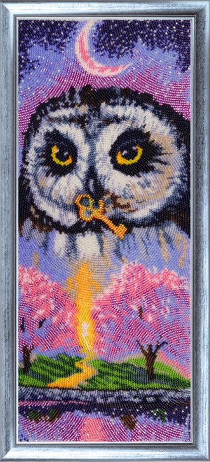 Bead embroidery kit depicting an owl with a background of a pink tree and a blue sky, including a full moon.