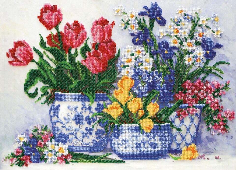 Cross-stitched design of flowers in a blue and white container