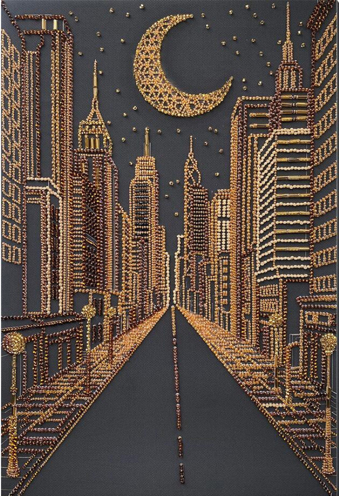 A diamond painting or bead art piece depicting a city skyline at night, featuring gold-toned skyscrapers and a crescent moon on a dark charcoal gray background.