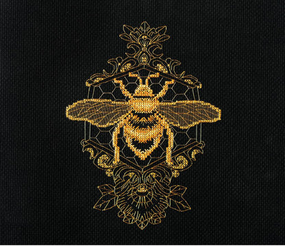 A cross stitch kit depicting a golden bee on a black background with ornate patterns.