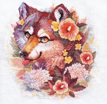 A cross stitch kit depicting a dog with floral elements, the kit includes threads, fabric, a symbol chart, a needle, and instructions.