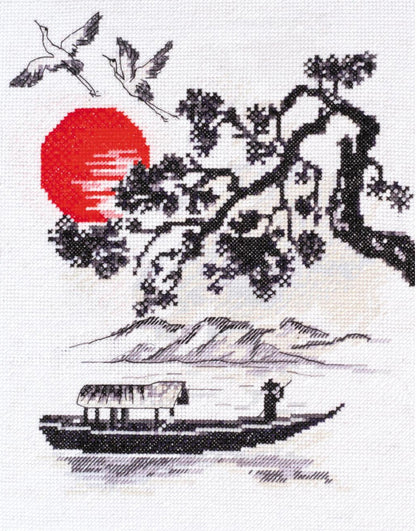 A cross stitch kit depicting a sunset scene with trees, a red sun, and a boat on the water.