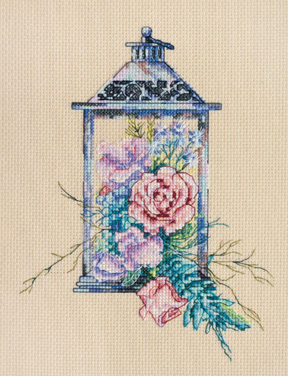 A cross stitch kit depicting a floral lantern design on unprinted canvas.