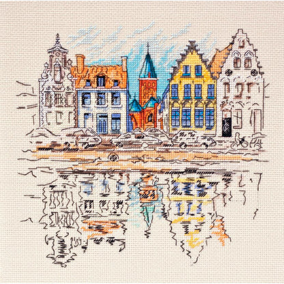 A cross stitch kit depicting a colorful town with buildings reflecting in water.
