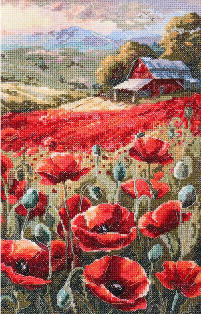 A cross stitch kit depicting a field of red poppies with a red barn in the background.