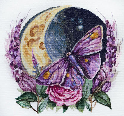 A cross stitch kit depicting a butterfly with a crescent moon and purple flowers.