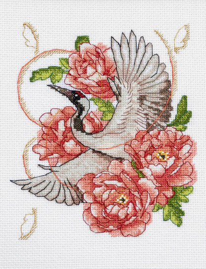 A cross stitch kit depicting a bird, possibly a stork, with extended wings surrounded by pink flowers. The kit includes Aida fabric, threads, a symbol chart, a needle, and instructions.