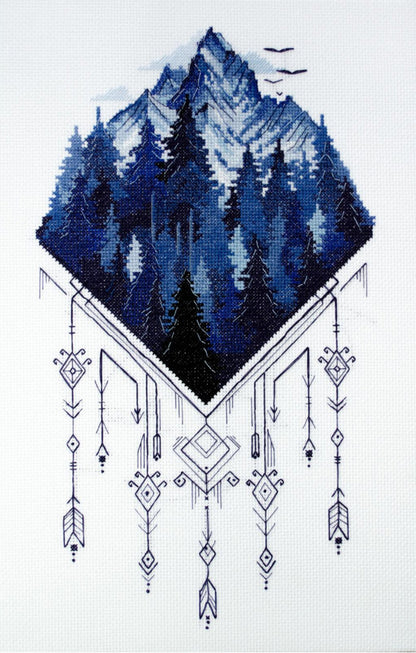 Counted cross stitch kit depicting a mountain landscape with trees and geometric patterns, unprinted canvas.
