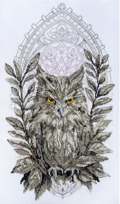 Cross stitch kit depicting a detailed owl with leafy branches in shades of gray and a fabric background.