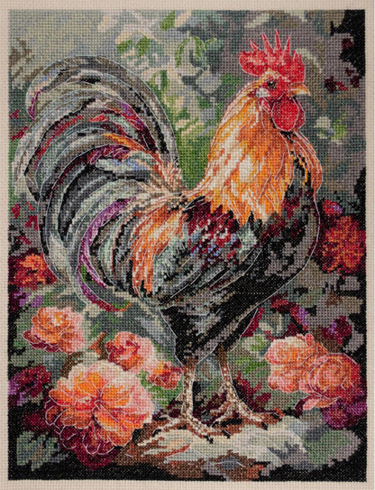 A completed counted cross stitch kit depicting a rooster among flowers, with a mix of green, orange, and gray colors.