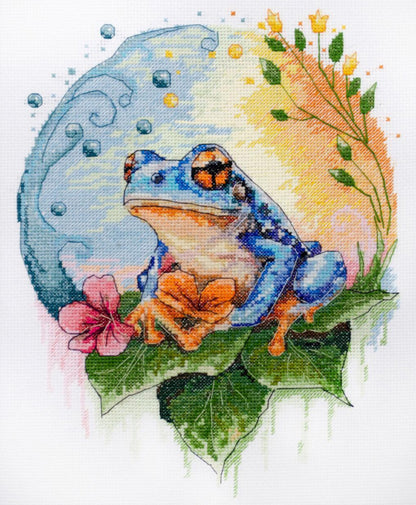 A cross stitch kit depicting a blue lizard on a leaf with a floral background.
