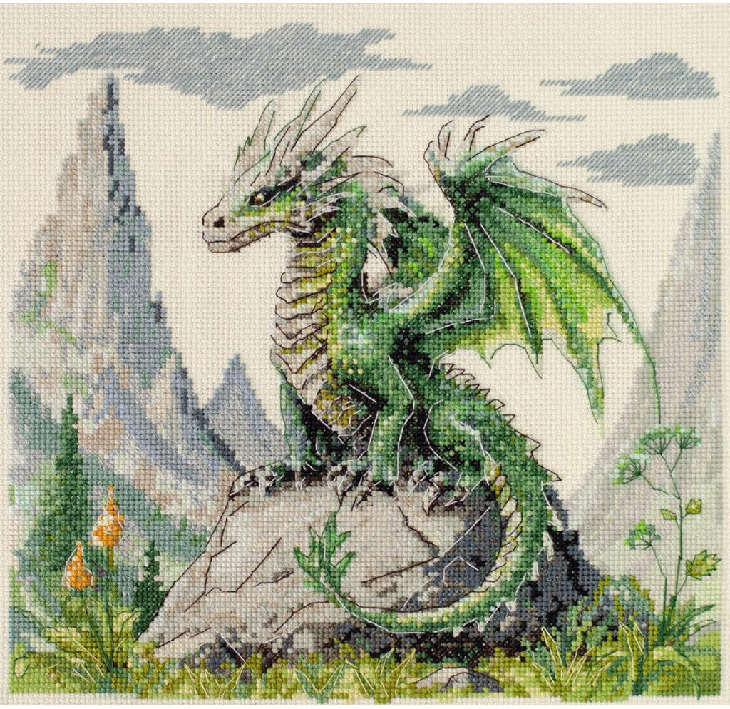 Cross-stitched green dragon on a rock with mountains and trees in the background