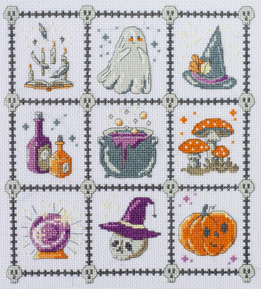 Cross-stitched pattern with Halloween-themed elements including a ghost, witch's hat, potion bottles, and pumpkins.