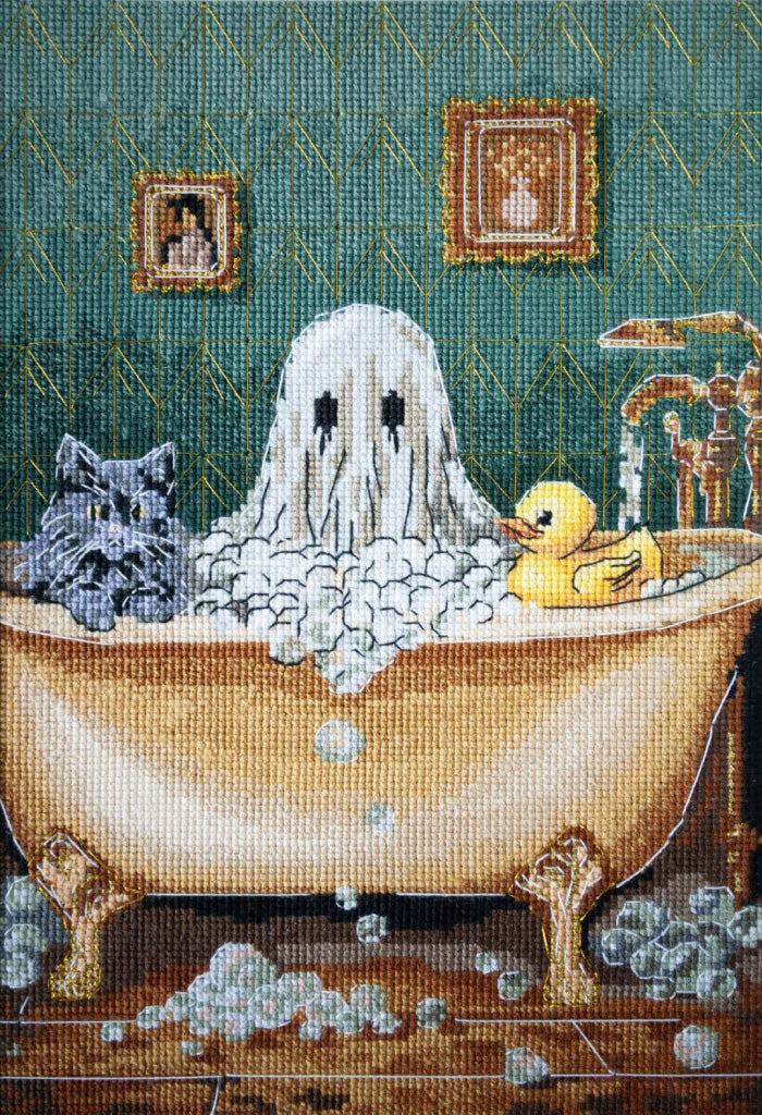 Cross-stitched artwork of a ghost in a bathtub with a cat and rubber duck.