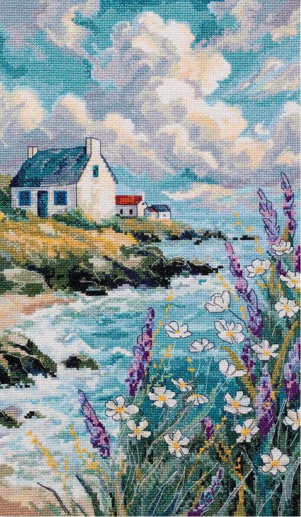 Cottage by a lakeside with flowers and clouds in the sky