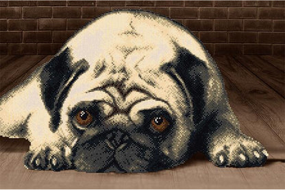 A bead embroidery kit depicting a dog, with the dog's face in focus and the rest of the image blurred.