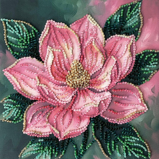 Decorative pink flower with green leaves made of beads on a dark background
