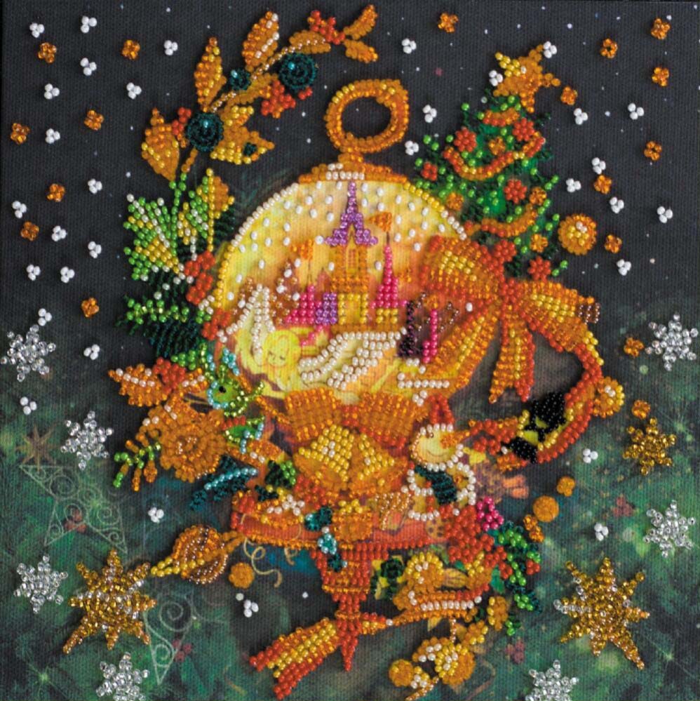 Decorative beadwork piece with a central circular design surrounded by festive elements on a dark background.