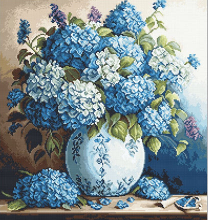 A Gobelin tapestry embroidery kit depicting a vase of blue hydrangeas, including unprinted canvas, a color photo of the finished picture, threads, a needle, and instructions.