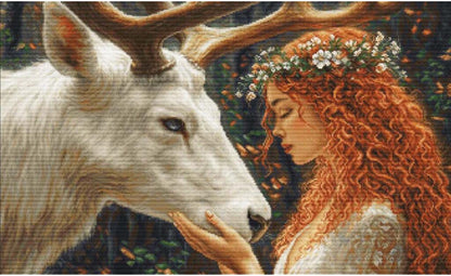 Cross-stitched design of a woman with red hair and a deer in a forest setting