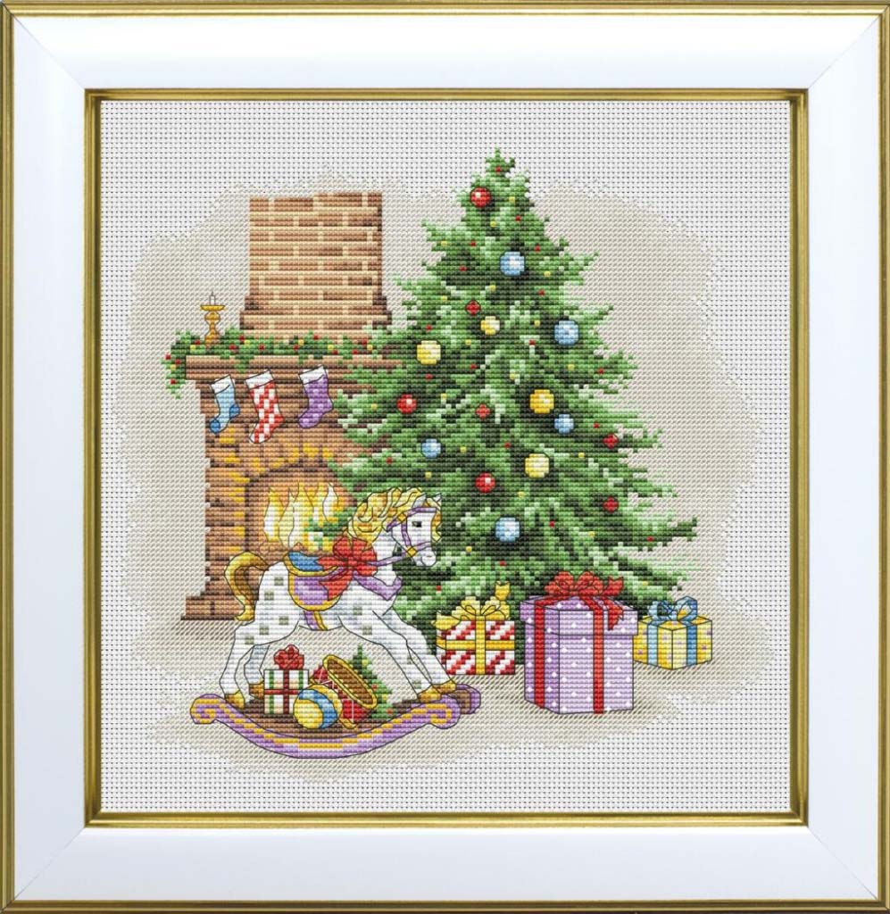 Cross-stitched scene of a child in front of a Christmas tree with presents and a rocking horse.