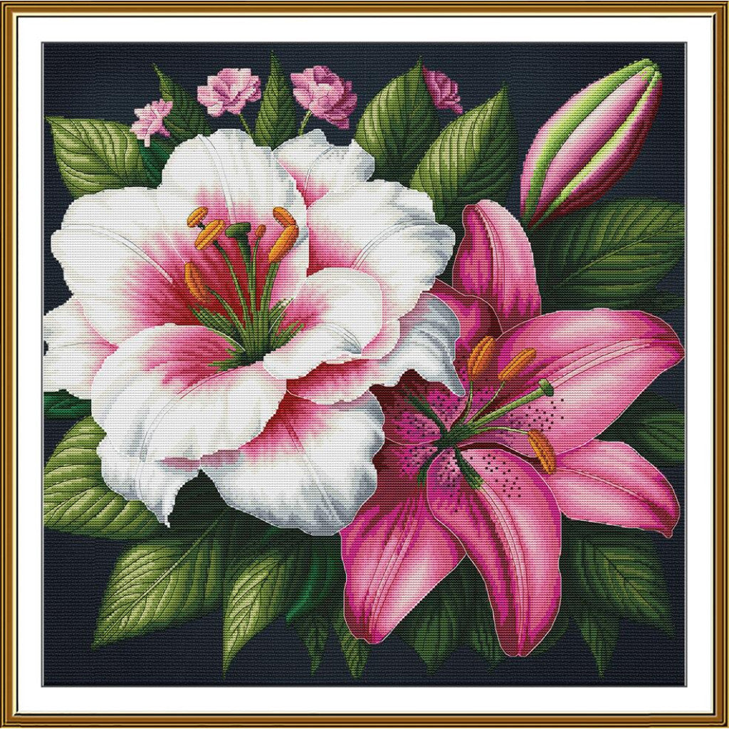 A framed floral artwork showing two large lilies, one white with pink shading and one pink, surrounded by green leaves and small pink buds on a dark background, enclosed in a white mat and gold frame.
