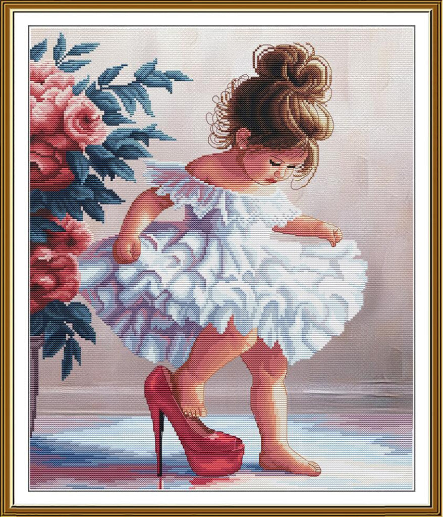 A framed needlepoint or cross-stitch style artwork showing a young girl in a white ruffled dress and red high heels beside pink flowers, surrounded by a gold-toned frame.