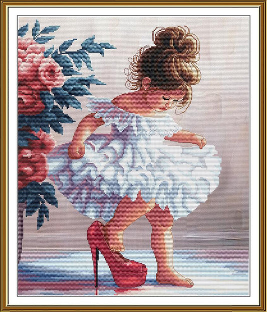 A framed needlepoint or cross-stitch style artwork showing a young girl in a white ruffled dress and red high heels beside pink flowers, surrounded by a gold-toned frame.