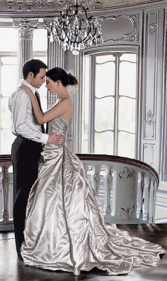 Man and woman in formal attire embracing in an elegant room with chandelier
