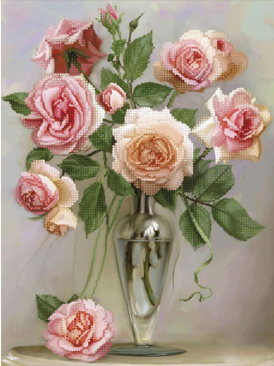 Bouquet of pink and white roses in a clear vase on a light background
