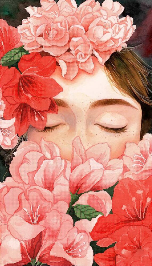 Woman's face with closed eyes surrounded by pink and red flowers